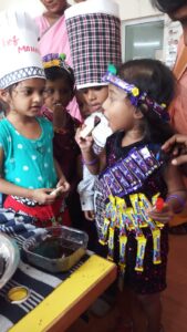 Children eating chocolate during Chocolate Day at RISHS International CBSE School Arcot