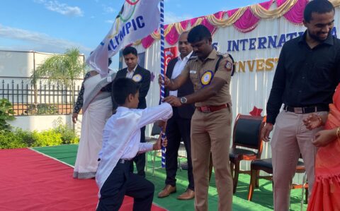 Handing over the flag during the Investiture ceremony at RISHS International CBSE School Arcot
