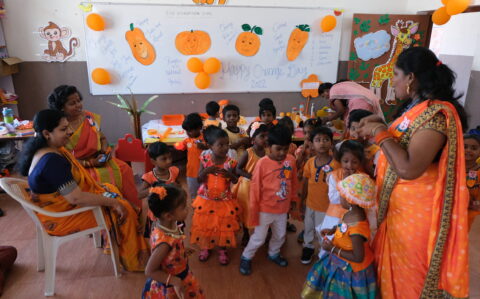 Kids and teacers with same orange colour themed dress in orange day at Rishs International CBSE School, Arcot