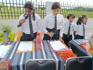 Mic on charge by students during the Investiture ceremony at RISHS International CBSE School Arcot