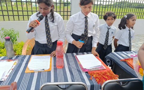 Mic on charge by students during the Investiture ceremony at RISHS International CBSE School Arcot