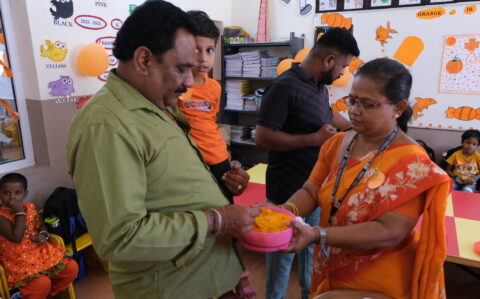 Parent Tasting Orange colour Food at Orange Day at RISHS International CBSE School Arcot