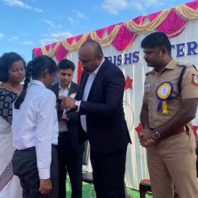 Presenting badge to the students in Investiture ceremony at RISHS International CBSE School Arcot