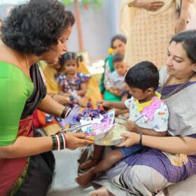 Principal giving chocolates to students during Vijayadasami at RISHS International CBSE School Arcot
