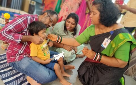 Principal giving Sweet to a Student during Vijayadasami at RISHS International CBSE School Arcot