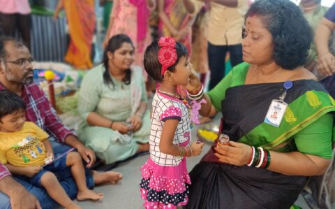 Principal giving Sweet to student during Vijayadasami at RISHS International CBSE School Arcot