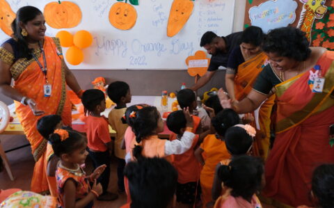 Principal meeting kids at Orange Day at RISHS International CBSE School Arcot