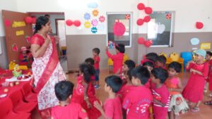 Teacher Playing With Kids at Red day Celebration at RISHS International CBSE School Arcot