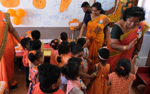 Teachers and Kids celebrating Orange day at RISHS International CBSE School Arcot