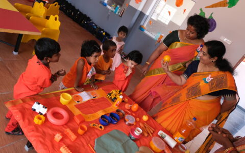 Teachers Teaching Orange things to Kids at Orange Day at RISHS International CBSE School Arcot